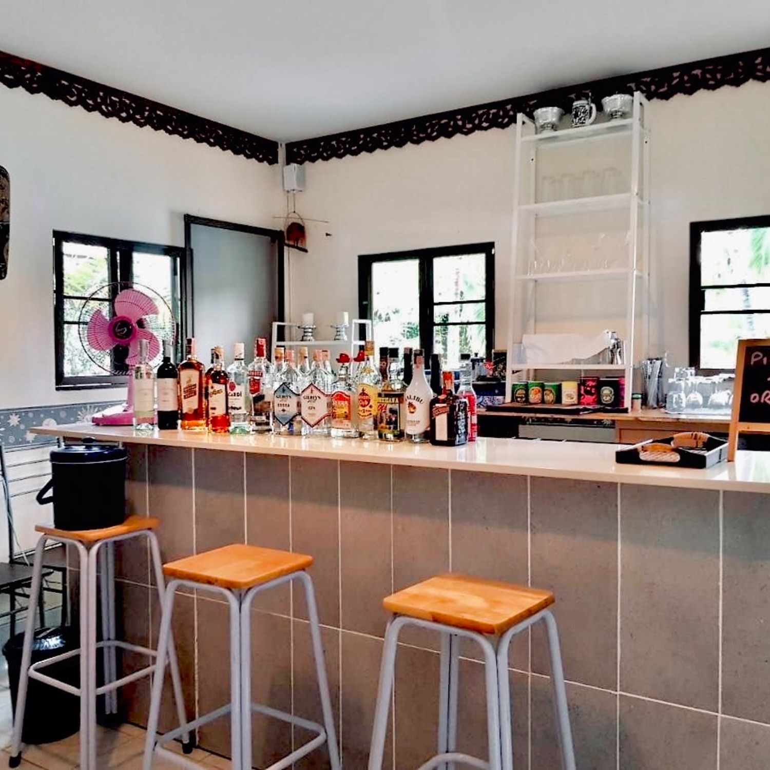 The bar at Lyndale Lodge stocked with spirits and wines, with bar stools