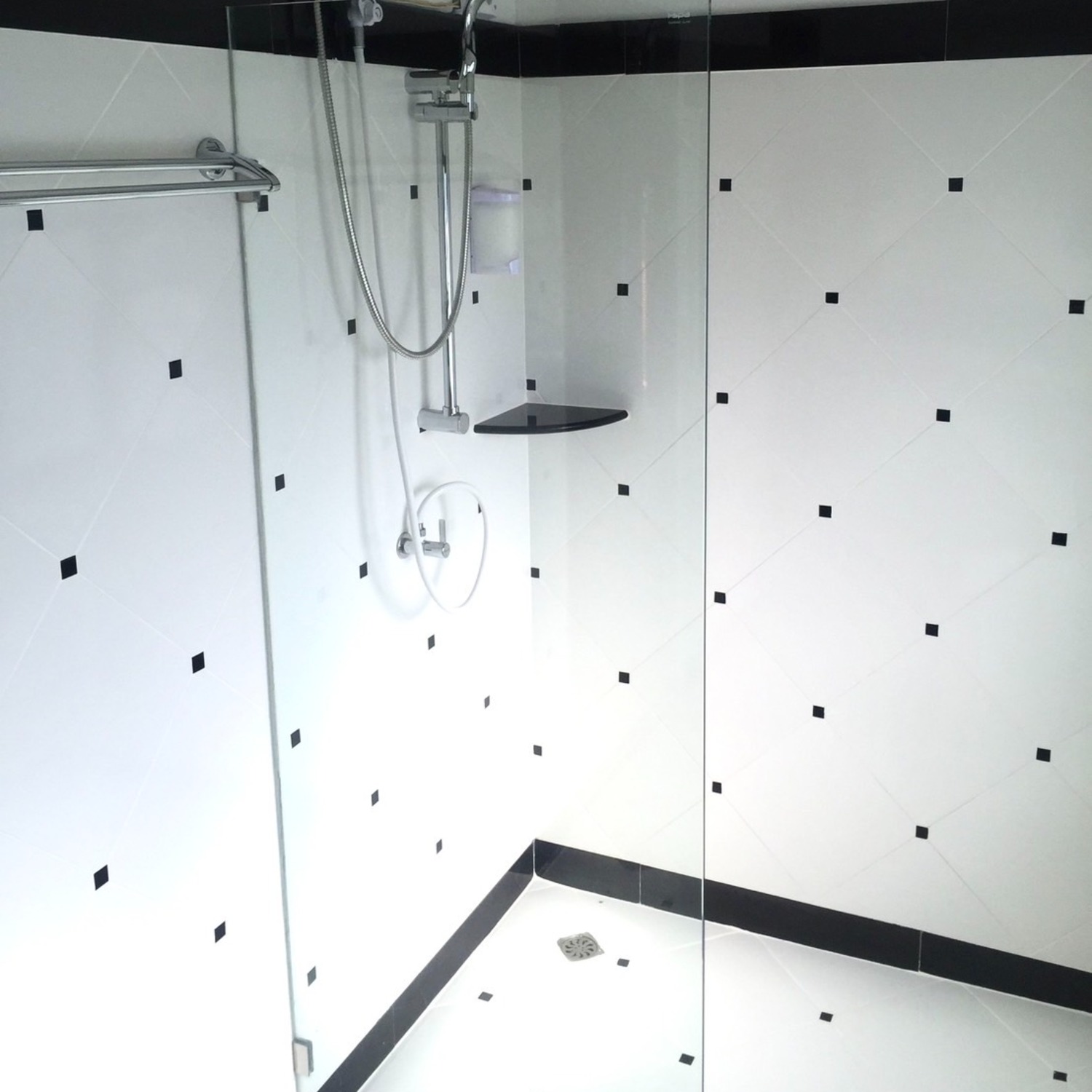 The white-tiled walk-in shower in the Superior Room bathroom at Lyndale Lodge