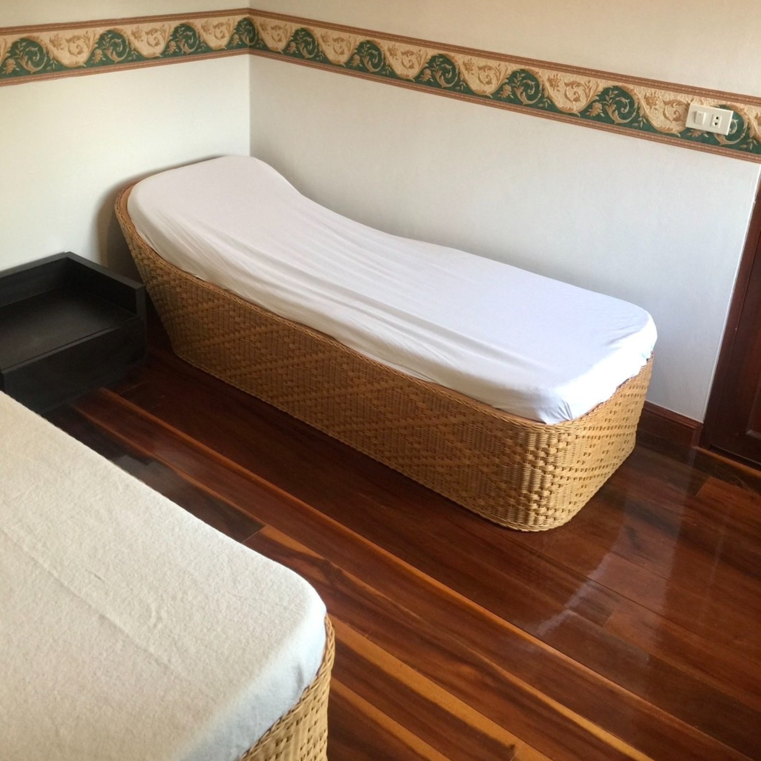 A twin Japanese futon on a woven rattan base in the Superior Room at Lyndale Lodge